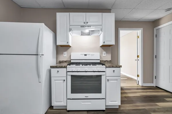 a white stove top oven and refrigerator