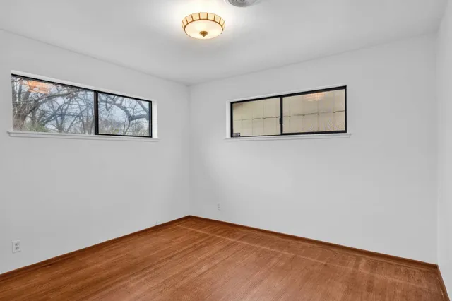 a view of a room with wooden floor and window