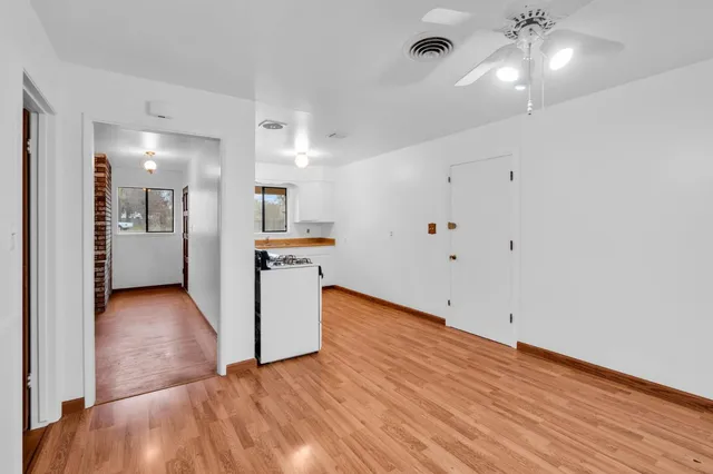 a view of a kitchen with wooden floor and a sink