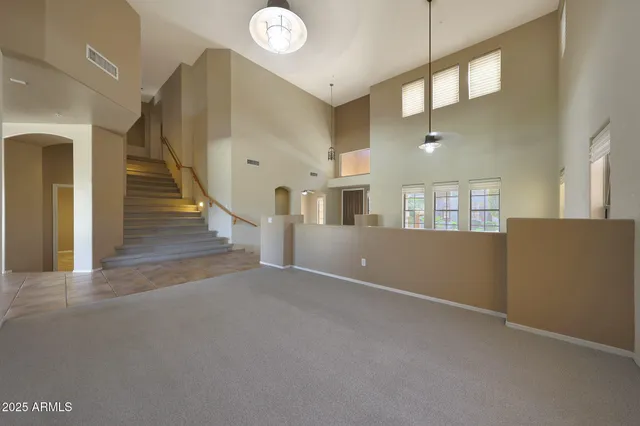 a view of an empty room with a fireplace and a window
