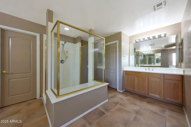 an aerial view of a house with a garden and lake view