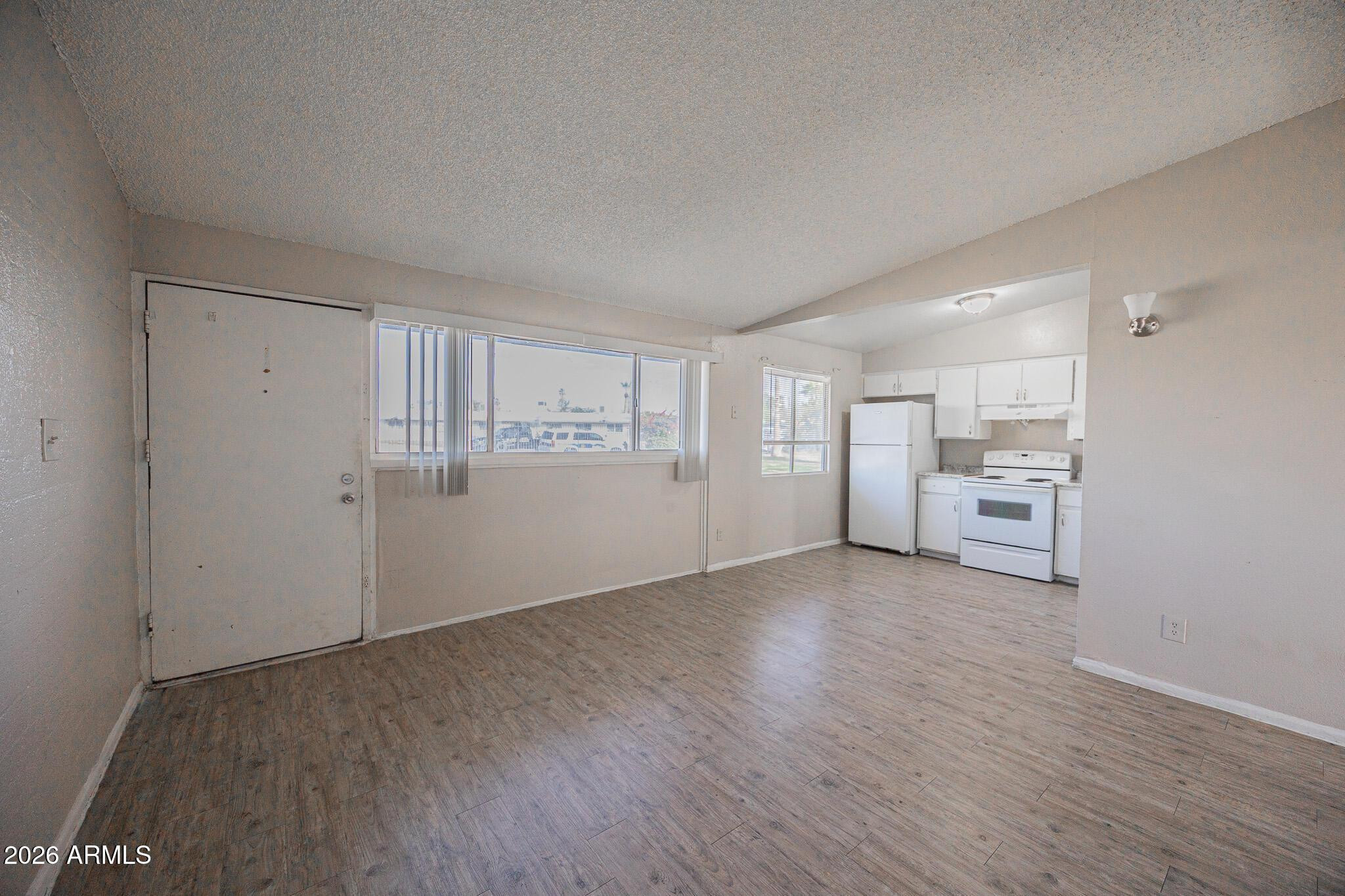 2123 West Devonshire Avenue, Unit 9 Phoenix, AZ 85015 - Photo 2 of 12 a view of a kitchen with wooden floor and a kitchen