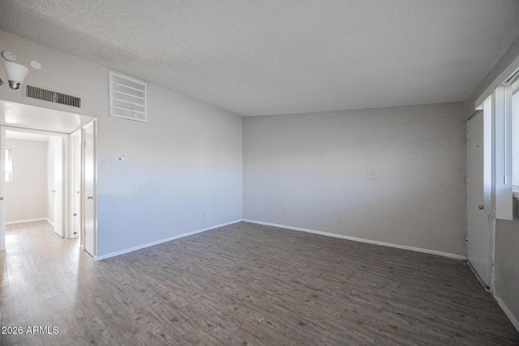 2123 West Devonshire Avenue, Unit 9 Phoenix, AZ 85015 - Photo 5 of 12 wooden floor in an empty room