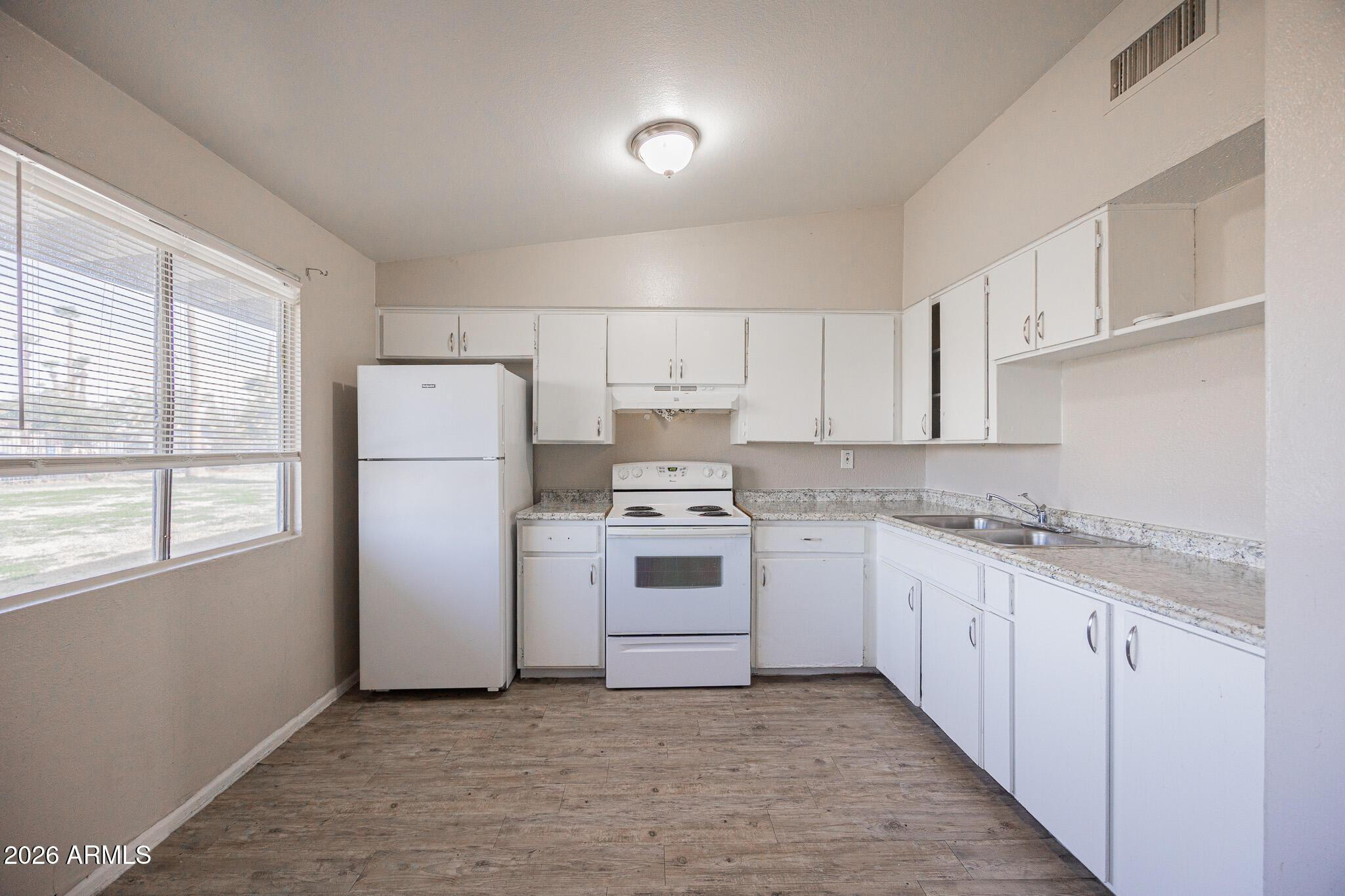 2123 West Devonshire Avenue, Unit 9 Phoenix, AZ 85015 - Photo 7 of 12 a kitchen with a stove top oven sink and cabinets