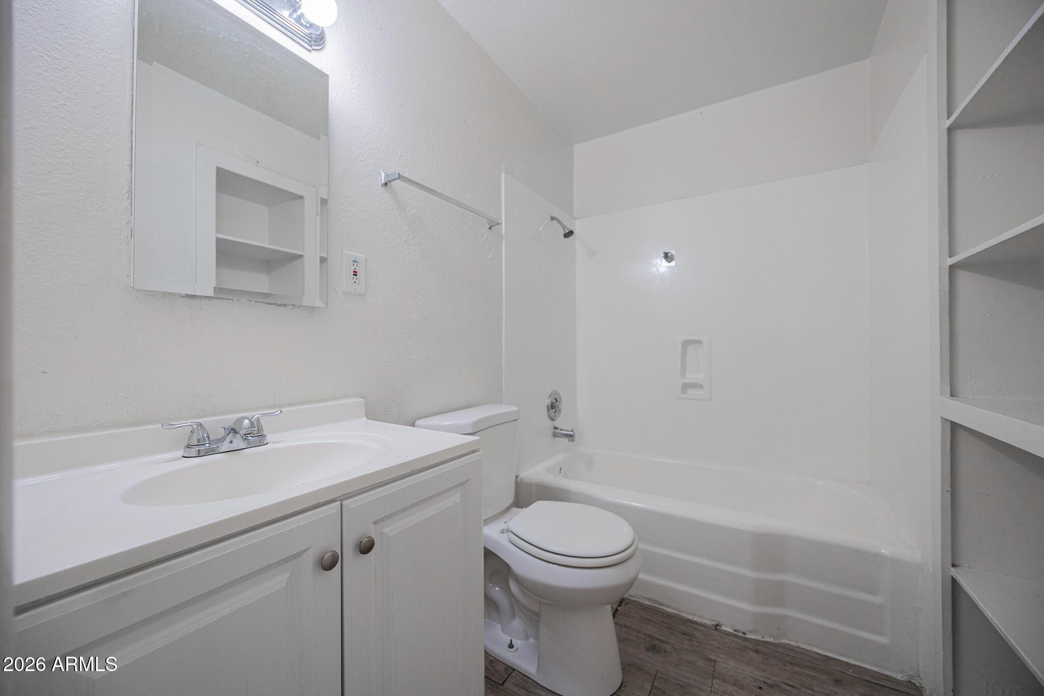 2123 West Devonshire Avenue, Unit 9 Phoenix, AZ 85015 - Photo 8 of 12 a bathroom with a sink a toilet and shower