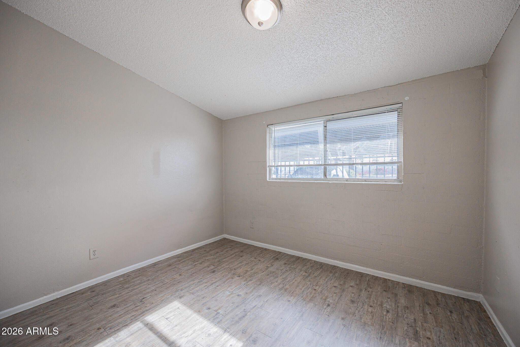 2123 West Devonshire Avenue, Unit 9 Phoenix, AZ 85015 - Photo 9 of 12 an empty room with a window