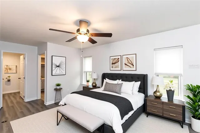 a bedroom with a bed a window and a dresser