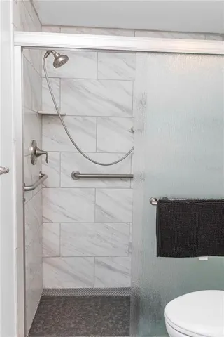 a view of a livingroom with wooden floor and a ceiling fan