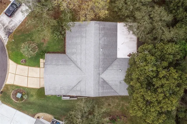 a room with lots of tables a large window and chairs