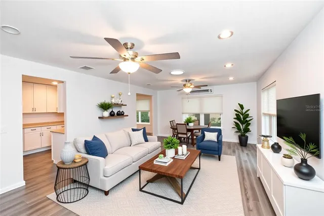 a living room with furniture and wooden floor