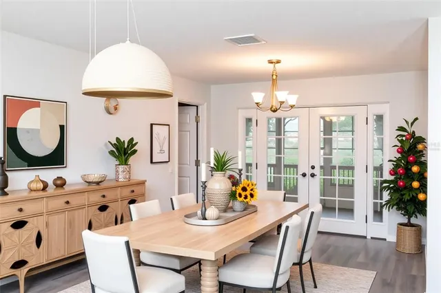 a view of a dining room with furniture and chandelier