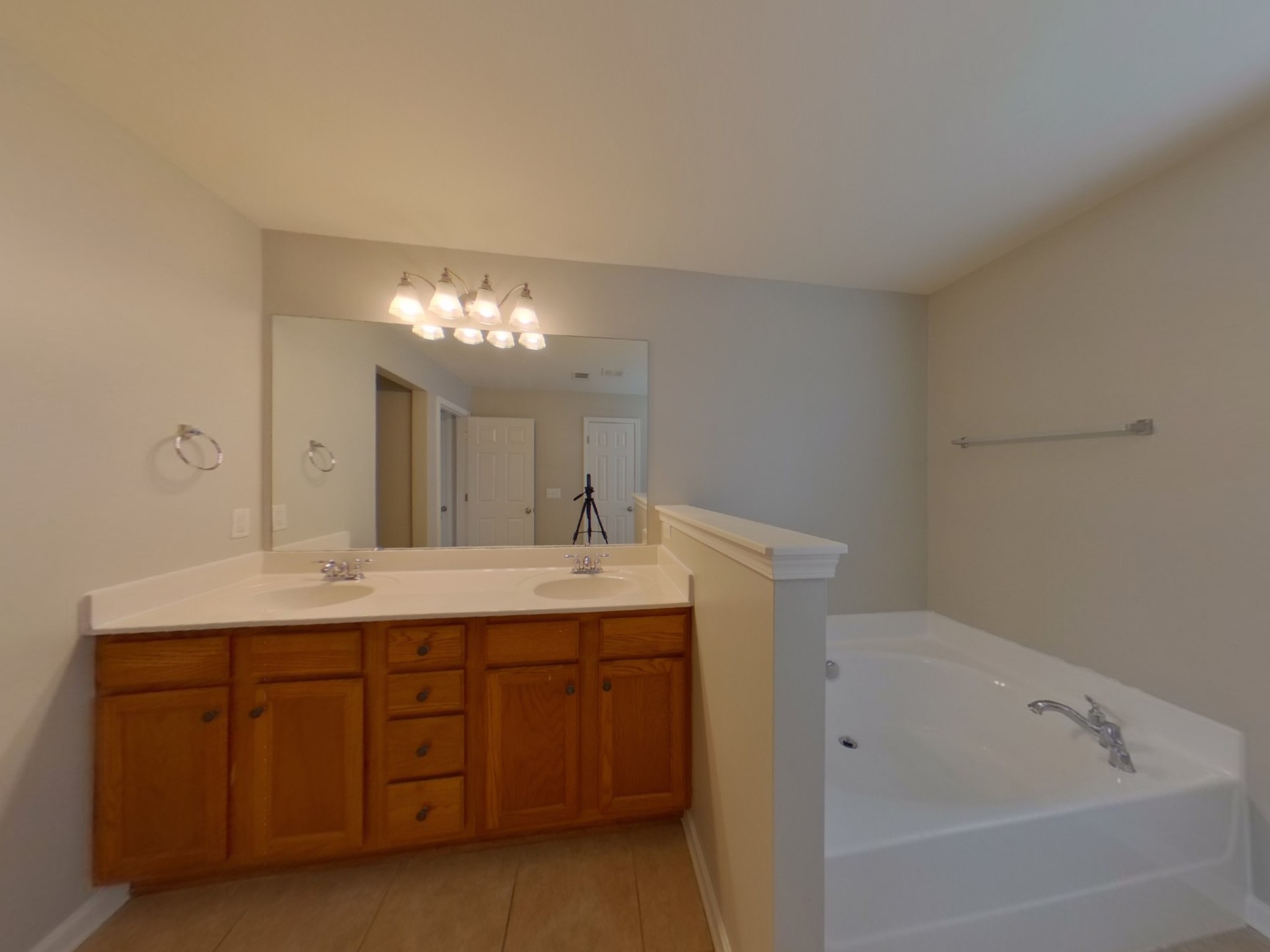 5001 Burtonwood Way Spring Hill, TN 37174 - Photo 15 of 20 a spacious bathroom with a granite countertop sink a mirror and a bathtub