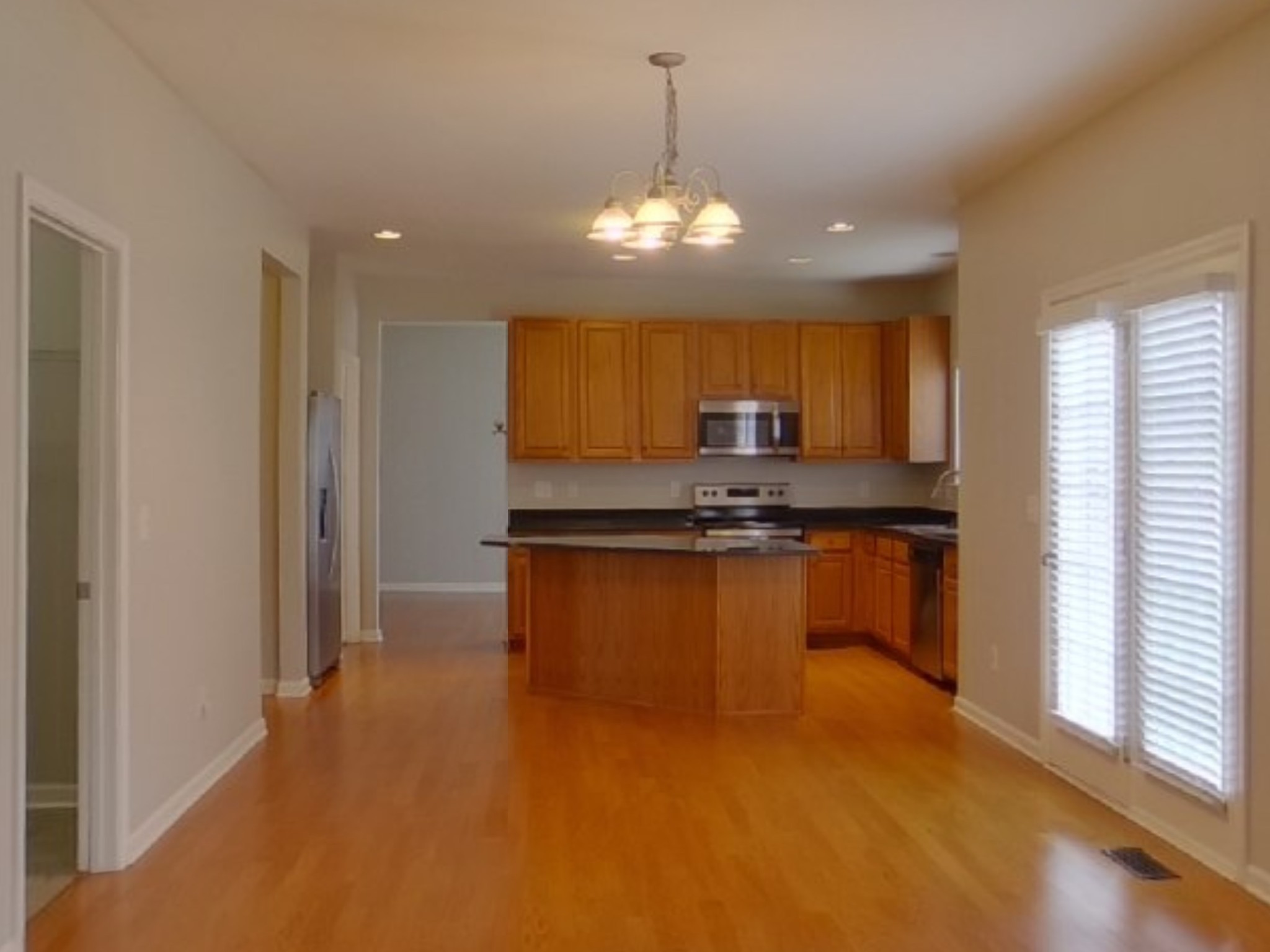 5001 Burtonwood Way Spring Hill, TN 37174 - Photo 4 of 20 a kitchen with stainless steel appliances granite countertop a refrigerator a sink dishwasher a stove and a dining table with wooden floor