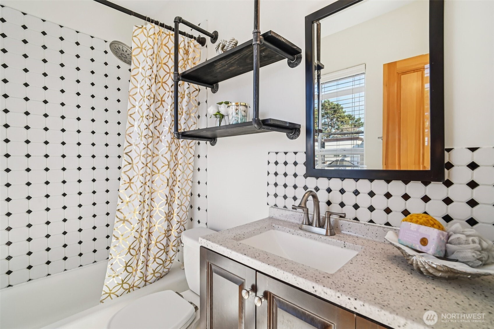 534 25th Avenue South Seattle, WA 98144 - Photo 15 of 35 a bathroom with a granite countertop sink a toilet and a shower curtain