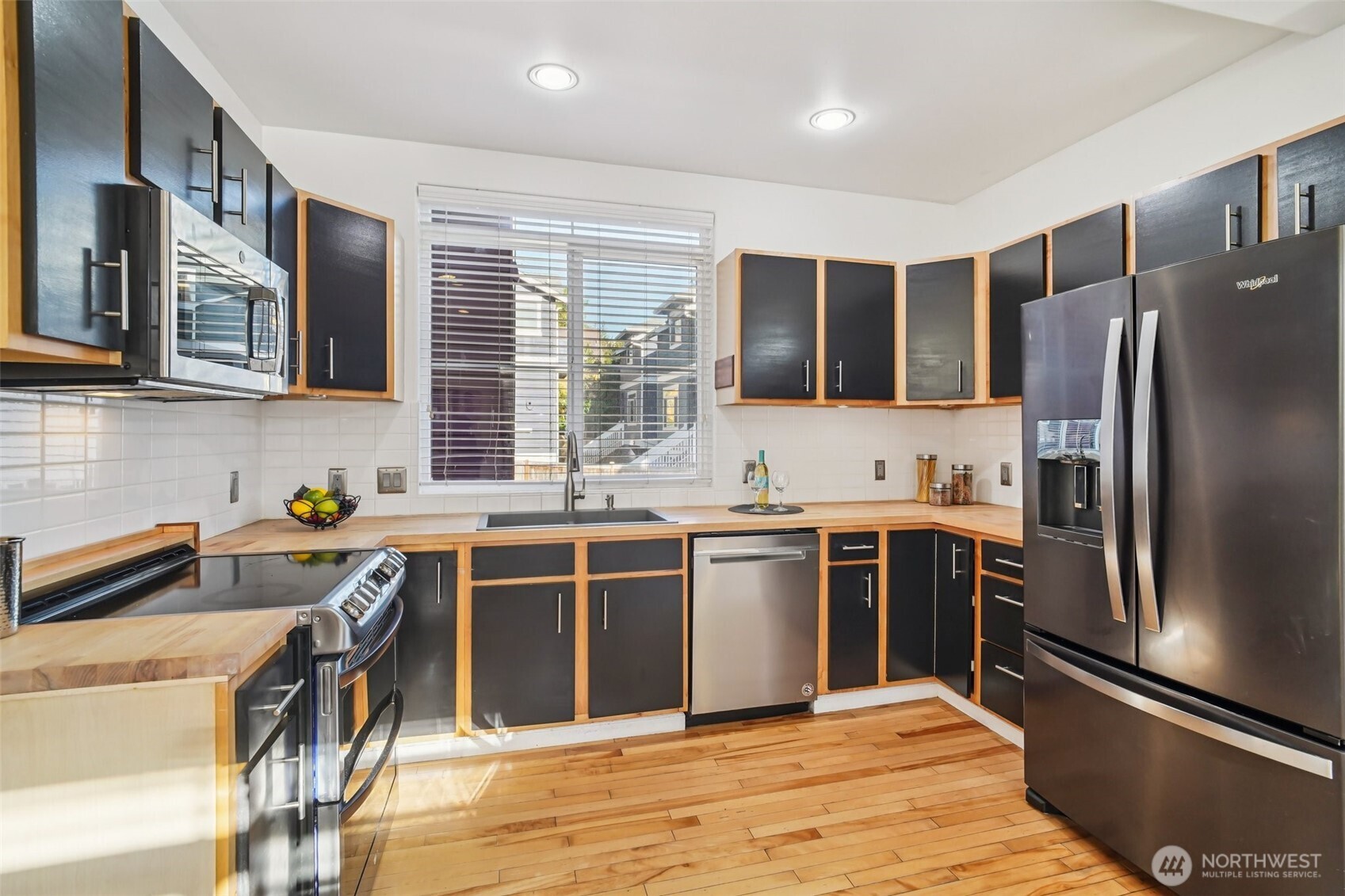 534 25th Avenue South Seattle, WA 98144 - Photo 10 of 35 a kitchen with stainless steel appliances granite countertop a refrigerator stove and sink
