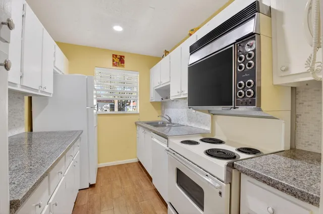 a kitchen with a stove and a sink