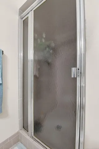 a bathroom with a glass shower door