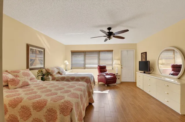 a bedroom with a large bed and a wooden floor