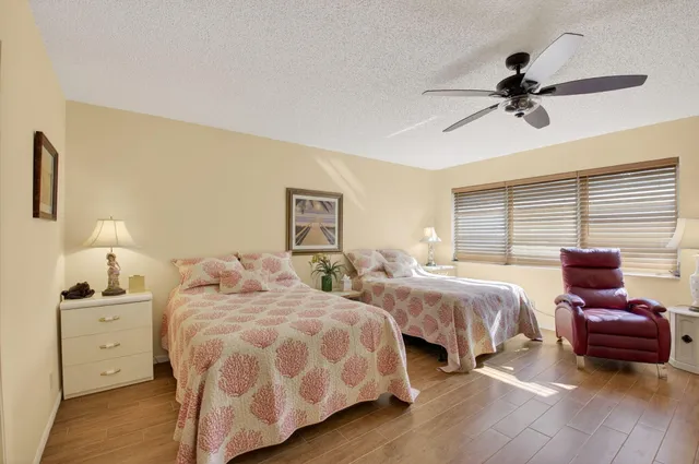 a bedroom with two beds and a window