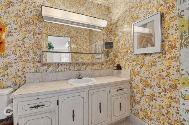 a bathroom with a sink a vanity and a mirror