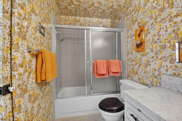 a bathroom with a toilet and a shower