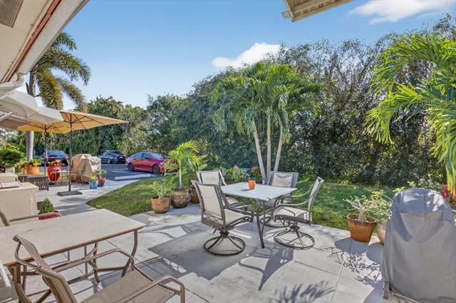 a view of a chairs and table in patio