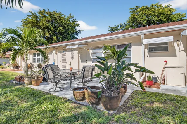 a view of backyard with outdoor seating and plants