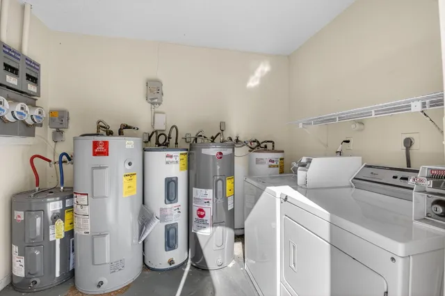 a utility room with multiple dryer and washer