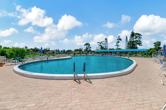 a view of a swimming pool and trees in the background
