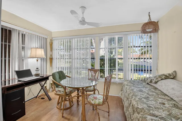 a dining room with furniture a chandelier and wooden floor