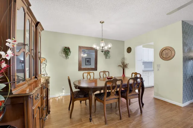 a view of a dining room with furniture and chandelier