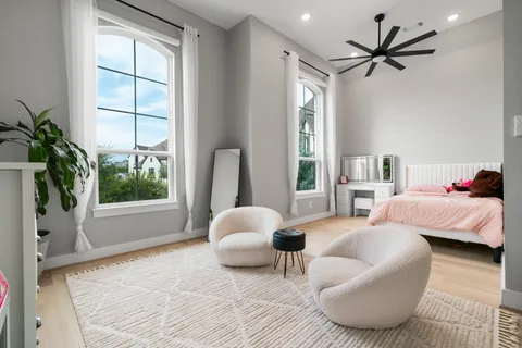 a bedroom with furniture and a large window