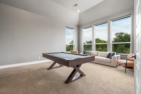 a living room with furniture a table and a large window