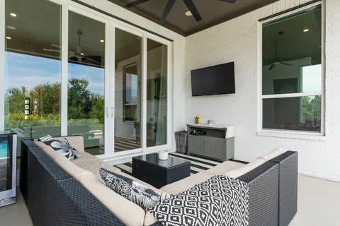 a living room with a flat screen tv and a floor to ceiling window