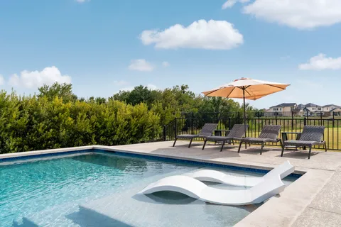 a view of a swimming pool with a lounge chair