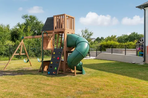 a childrens park with lots of swings and slides