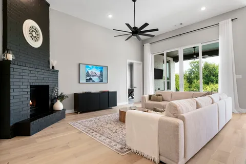 a living room with furniture a clock and a fireplace