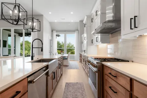 a kitchen with stainless steel appliances granite countertop a stove and a sink