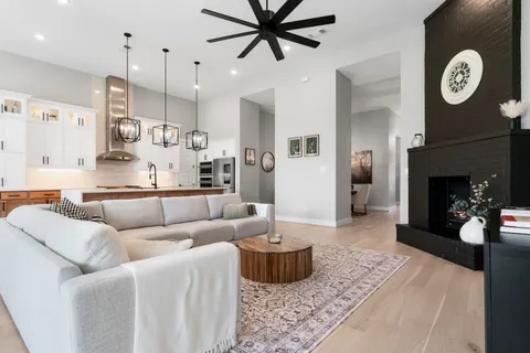a living room with furniture a clock and a fireplace