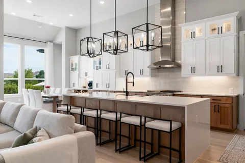 a kitchen with stainless steel appliances granite countertop a stove a sink and a refrigerator