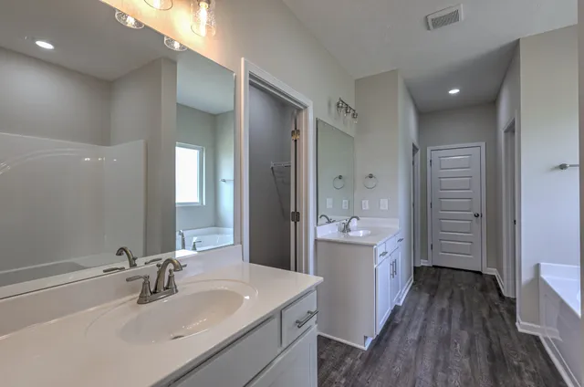 a bathroom with a tub and shower