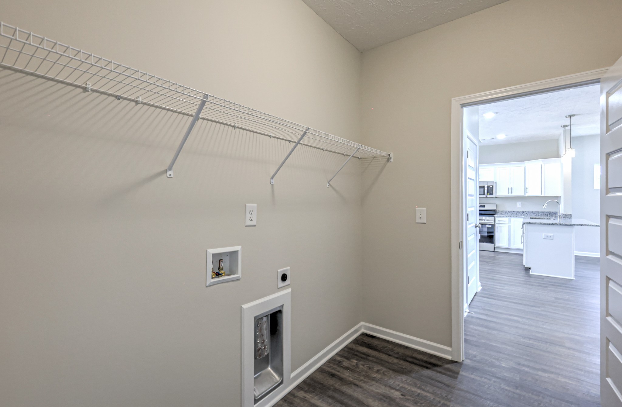 22 Bartow Street Decherd, TN 37324 - Photo 23 of 38 a view of a storage & utility room with wooden floor