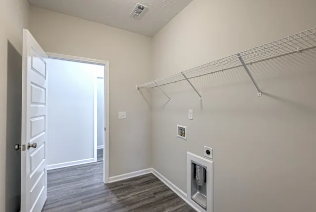 a view of a hallway with wooden floor and closet