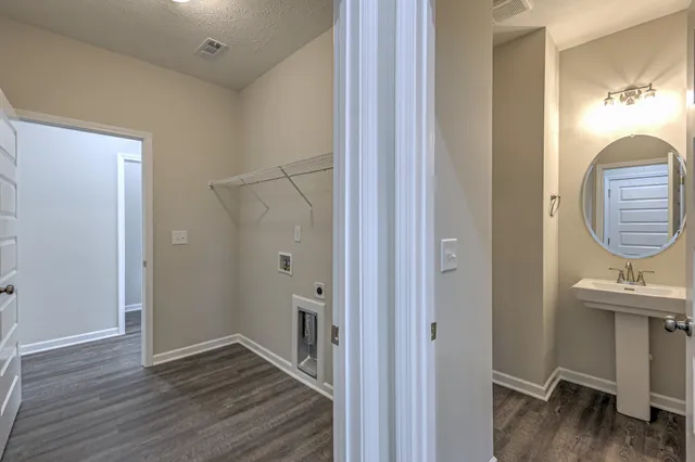 a kitchen with kitchen island granite countertop a refrigerator and a sink