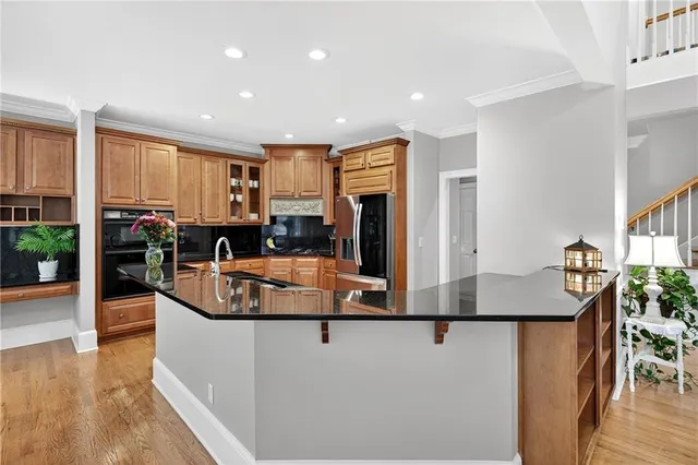 a kitchen with granite countertop a stove and a white cabinets
