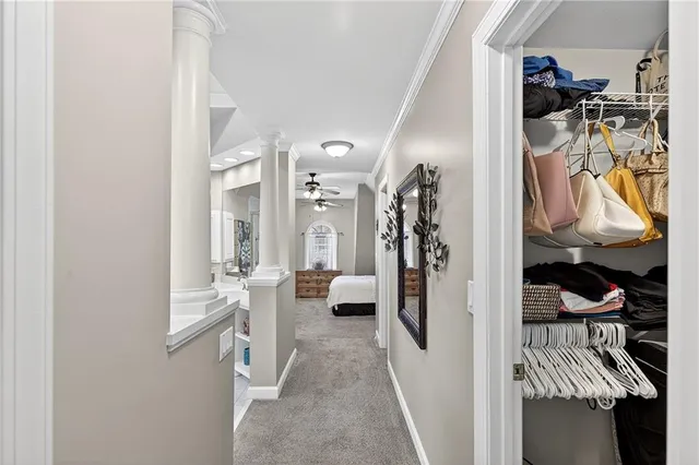 a bedroom with a large bed chandelier and a window