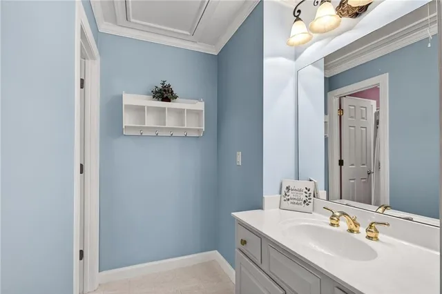 a bedroom with a bed and dresser with wooden floor