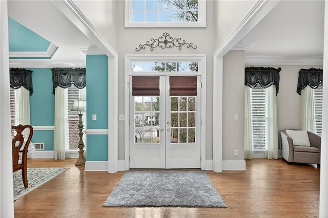 a living room with furniture a table and a large window