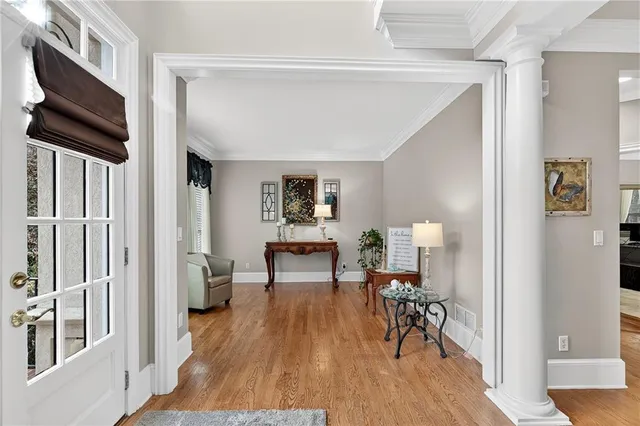a view of a livingroom with wooden floor and furniture