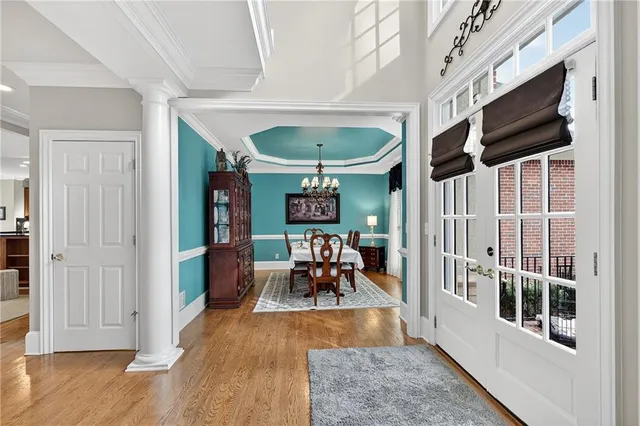 a living room with furniture floor to ceiling window and a flat screen tv